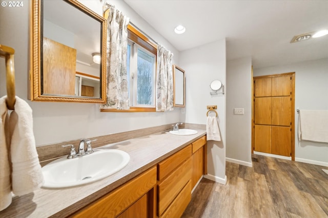 bathroom with vanity and hardwood / wood-style flooring