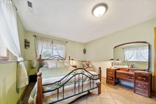 tiled bedroom with multiple windows