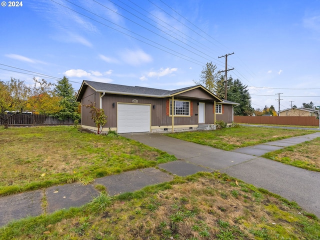 ranch-style house featuring a garage and a front yard