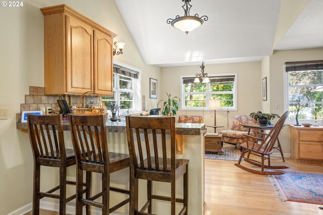 kitchen featuring pendant lighting, lofted ceiling, and a wealth of natural light