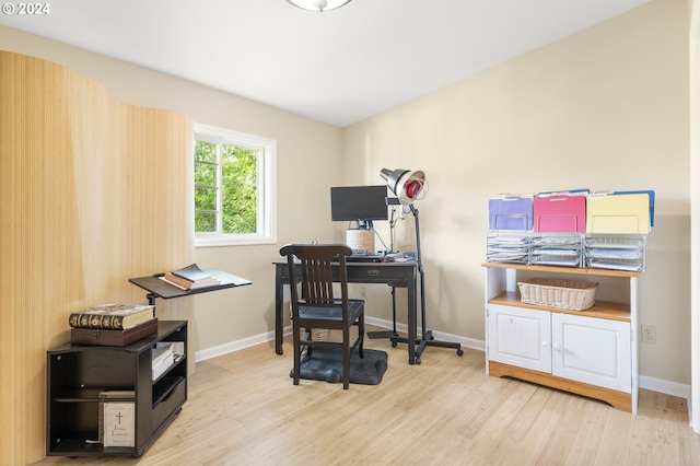 home office with light hardwood / wood-style floors