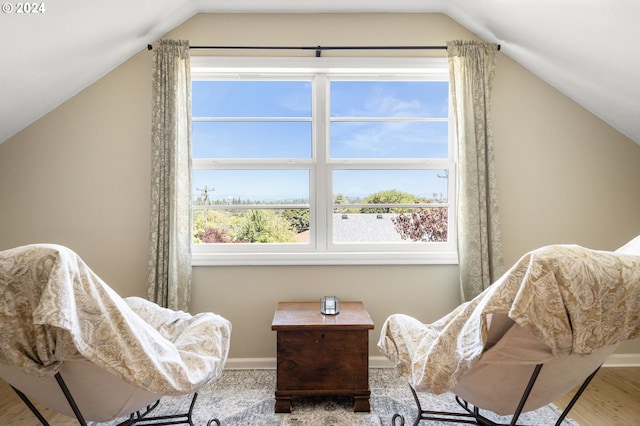 sitting room featuring hardwood / wood-style flooring, a wealth of natural light, and vaulted ceiling