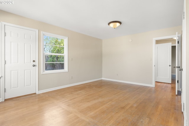 empty room with light hardwood / wood-style flooring