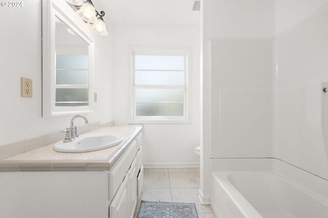 bathroom featuring tile patterned flooring, vanity, and toilet