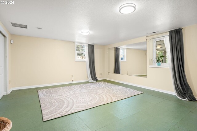 exercise room featuring a textured ceiling