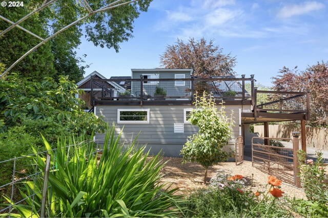 back of house with a wooden deck