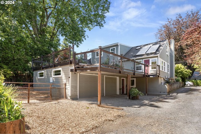 view of front property with solar panels and a deck