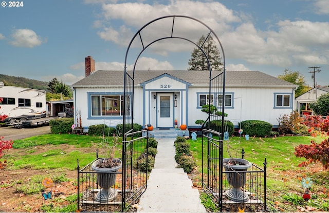 bungalow-style house with a front lawn