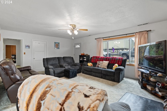 living room featuring a textured ceiling, carpet floors, and ceiling fan