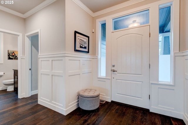 foyer entrance with dark hardwood / wood-style flooring and ornamental molding