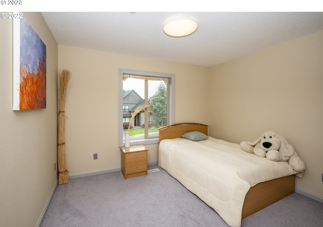 bedroom featuring light carpet