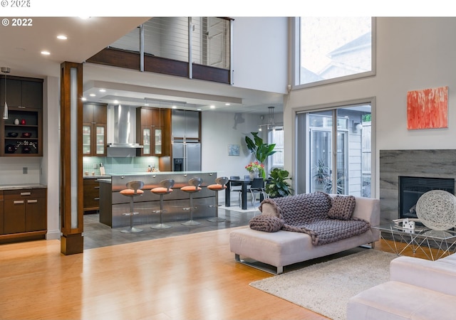 living room featuring a high ceiling and light wood-type flooring