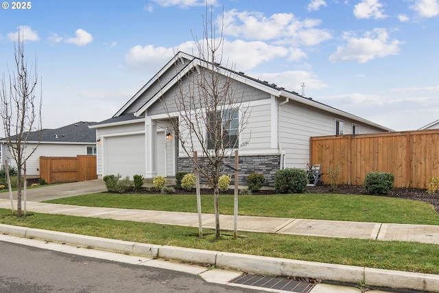 view of front of home with a front yard and a garage