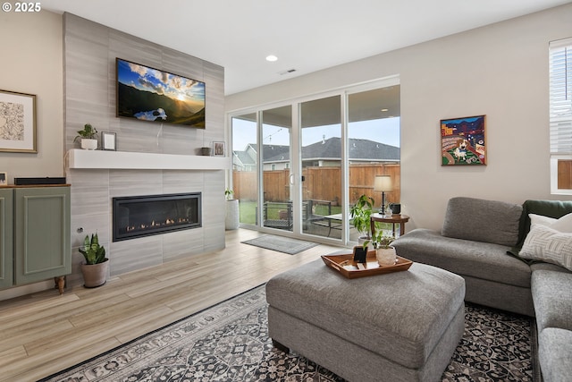 living room featuring a tiled fireplace