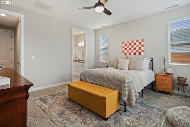 carpeted bedroom with connected bathroom and ceiling fan