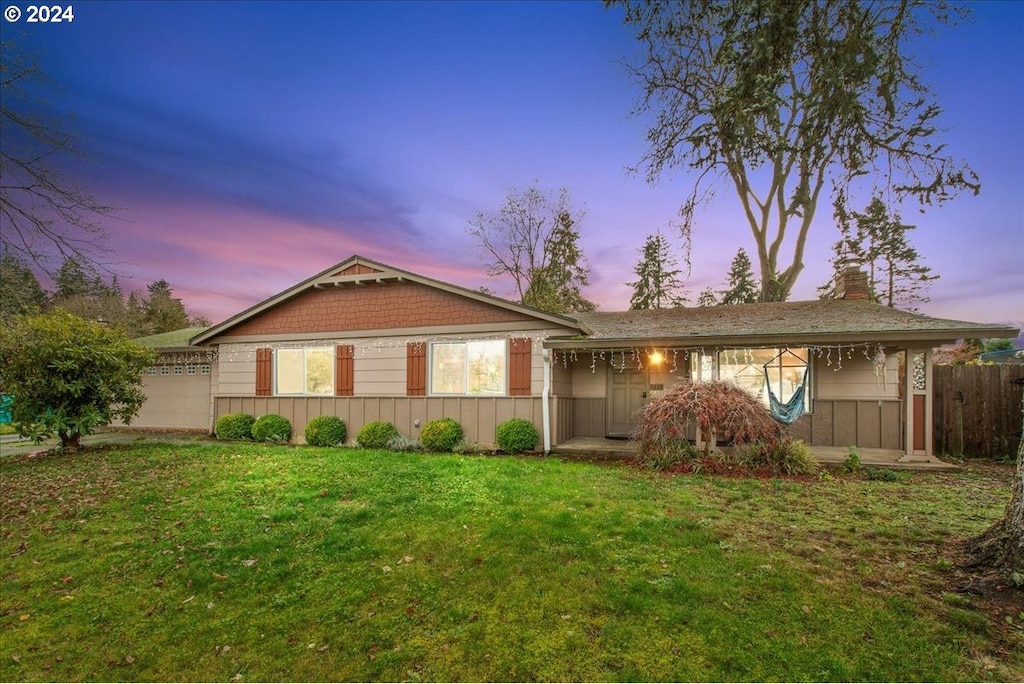 view of front of house with a lawn and a garage