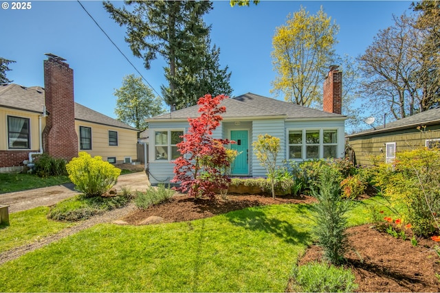 bungalow-style home featuring a front yard and a chimney