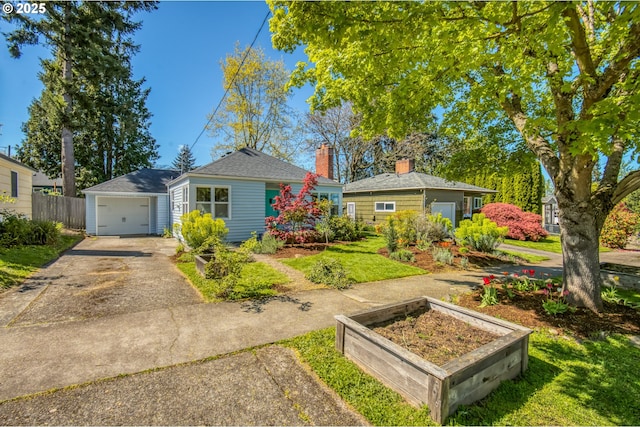 bungalow-style house featuring asphalt driveway, a chimney, and a garden