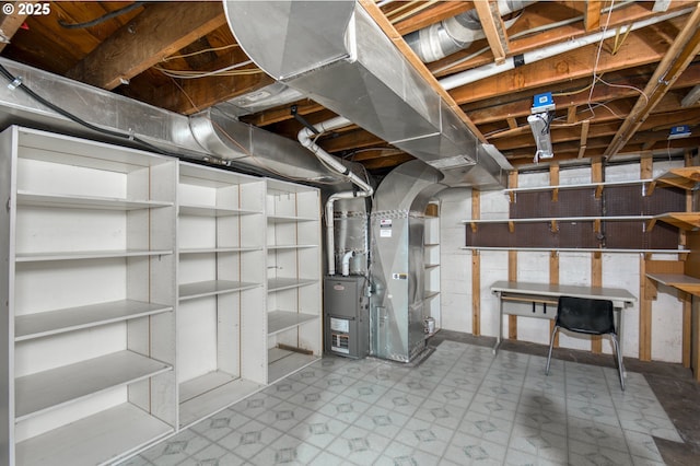 unfinished basement featuring tile patterned floors and heating unit
