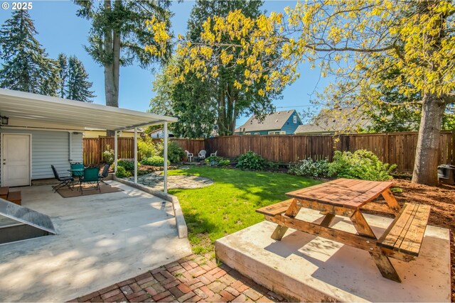 view of yard with outdoor dining space and a patio