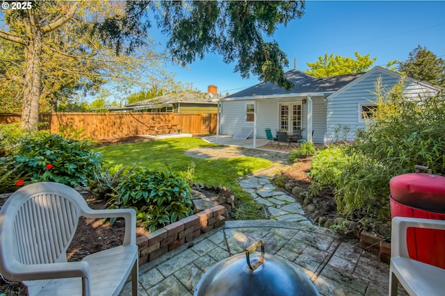view of yard featuring a patio area and french doors
