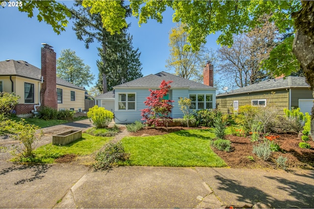 view of front facade with a front yard and a chimney