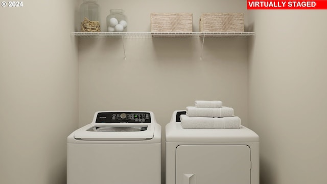 clothes washing area with washer and dryer