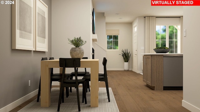 dining area featuring plenty of natural light and light hardwood / wood-style flooring