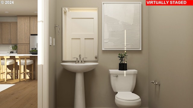 bathroom featuring toilet and hardwood / wood-style floors