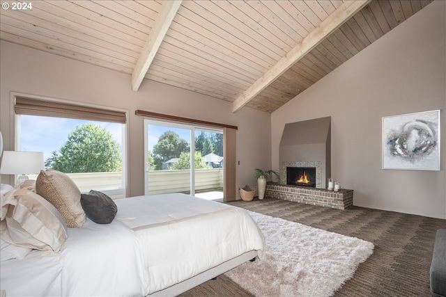 bedroom with access to outside, dark colored carpet, beamed ceiling, wooden ceiling, and a fireplace