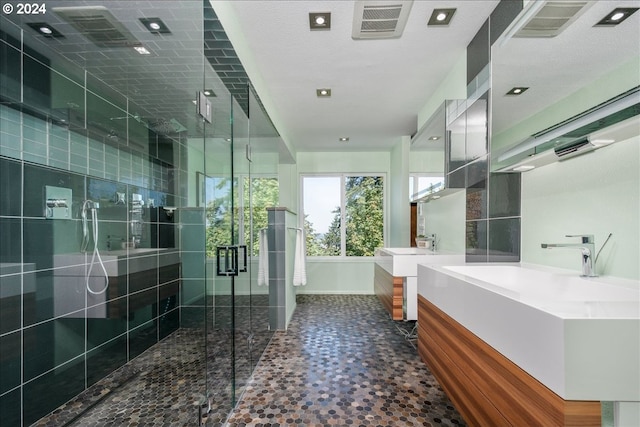 bathroom with vanity and a shower with shower door