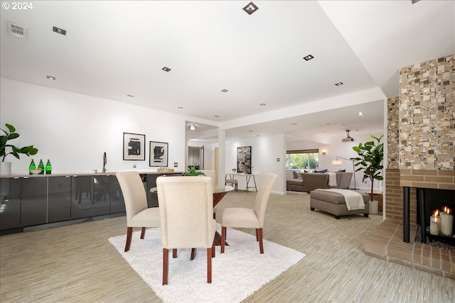 dining room with sink and a fireplace