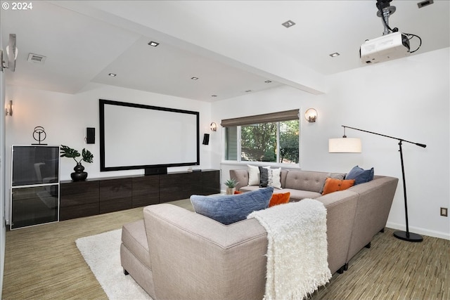 home theater room featuring beamed ceiling and wood-type flooring