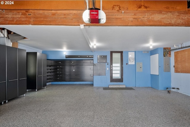 garage featuring electric panel and a garage door opener