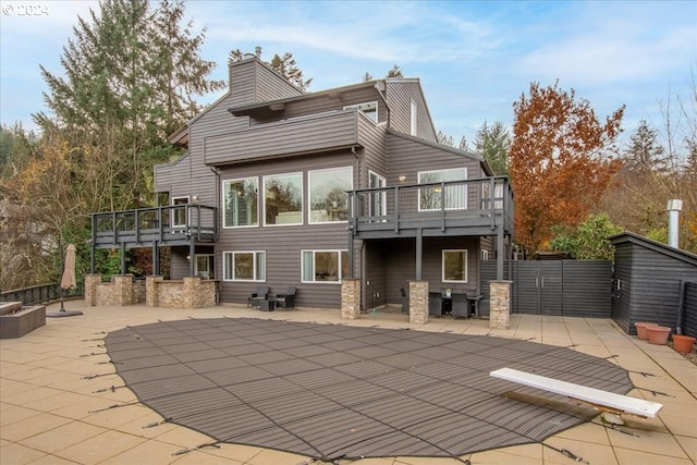 back of house with a patio and a deck