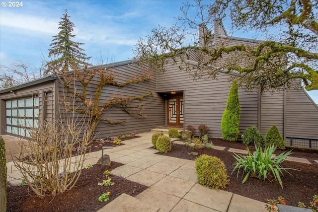 exterior space featuring a garage and french doors