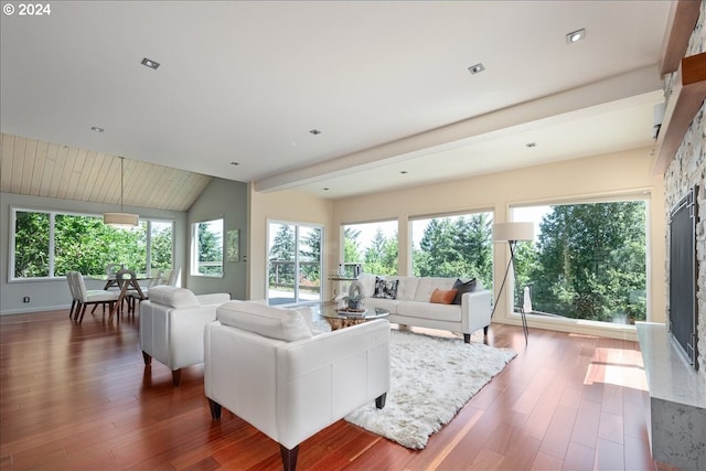 living room featuring hardwood / wood-style floors, a fireplace, and vaulted ceiling