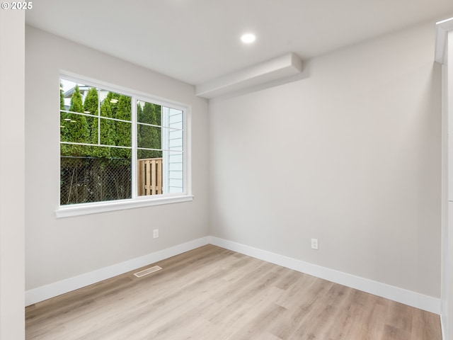 spare room featuring light wood-type flooring