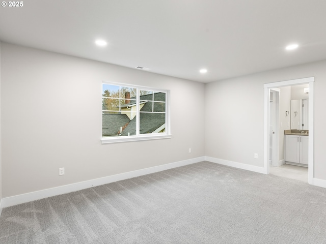 unfurnished room with light carpet