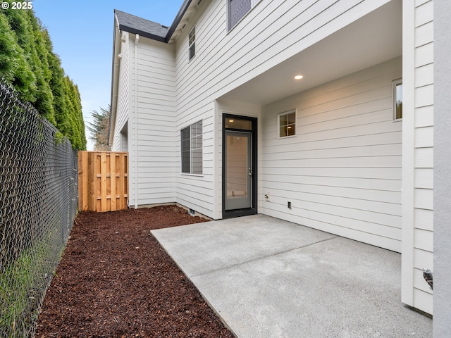 view of exterior entry featuring a patio area