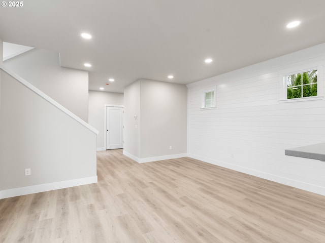 basement with light hardwood / wood-style flooring