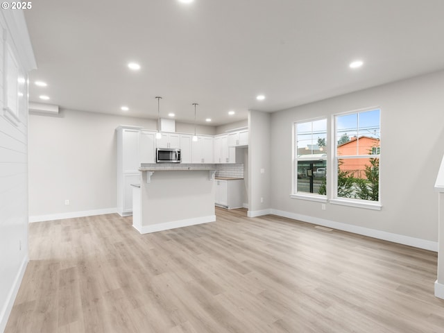 unfurnished living room featuring light hardwood / wood-style floors