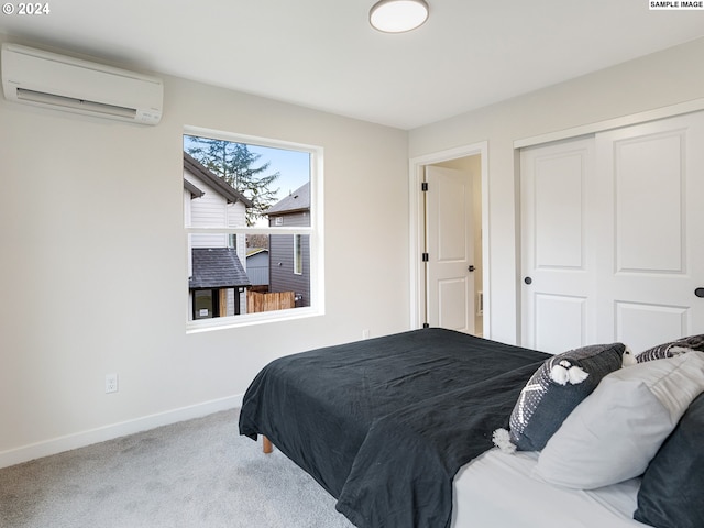 bedroom featuring a wall unit AC, a closet, and carpet floors