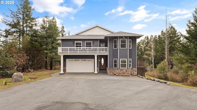 view of front of home with a balcony and a garage