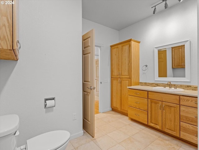 bathroom featuring vanity, toilet, and tile patterned flooring