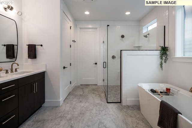 1004 S Mountain Pl, Ridgefield, WA 98642 - full bath featuring vanity, a shower stall, a soaking tub, marble finish flooring, and baseboards