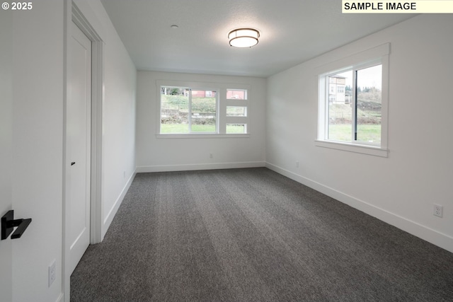 1004 S Mountain Pl, Ridgefield, WA 98642 - spare room featuring dark carpet and baseboards