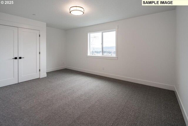 1004 S Mountain Pl, Ridgefield, WA 98642 - unfurnished bedroom featuring baseboards, carpet floors, and a closet