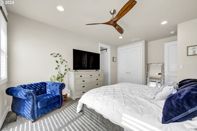 carpeted bedroom with a closet and ceiling fan