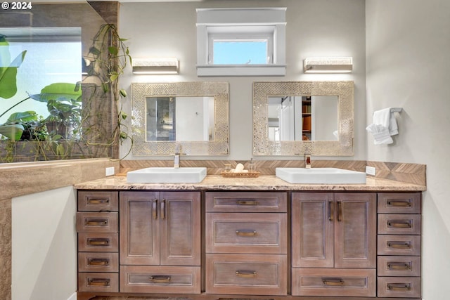 bathroom featuring a wealth of natural light and vanity